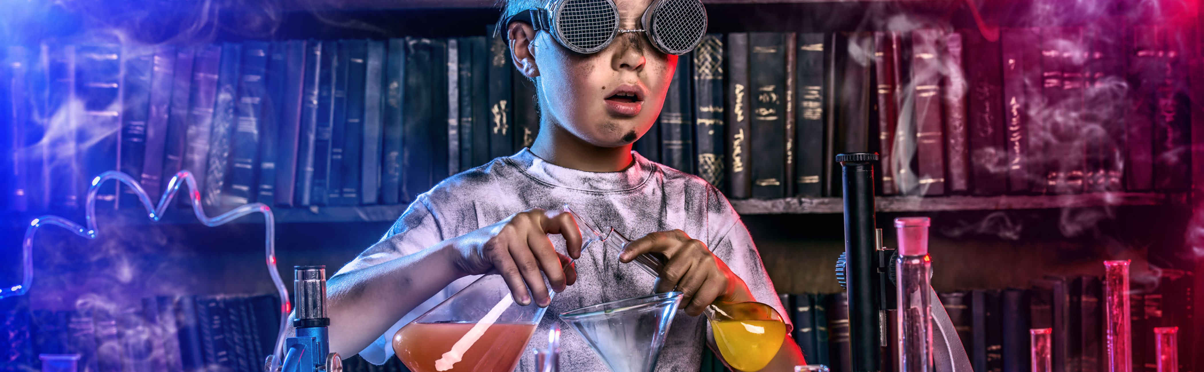 A young scientist performing experiments in a lab covered in soot.